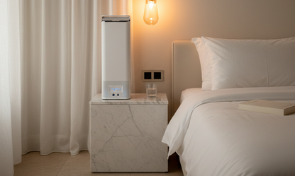Hextio HX-100 personal air purifier on a marble nightstand in a softly lit bedroom